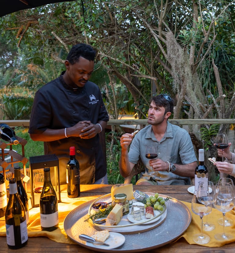 The chef talks a couple through the wines at a cheese table on the deck.